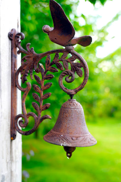 istock Decorative garden old rusty bell with bird 1415032551