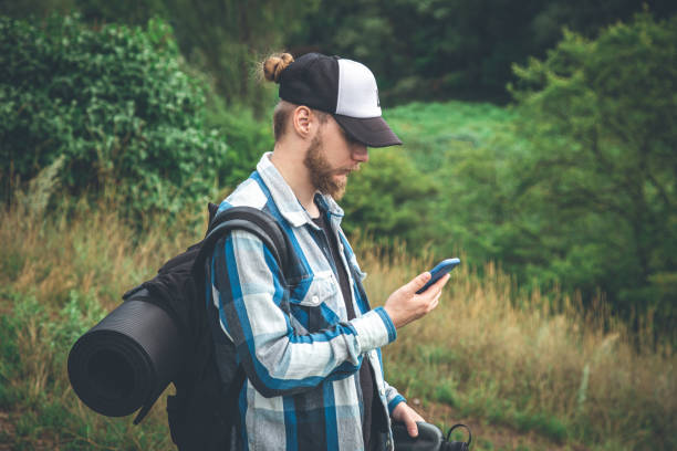 istock A male traveler with a backpack looks into a smartphone. 1415034032