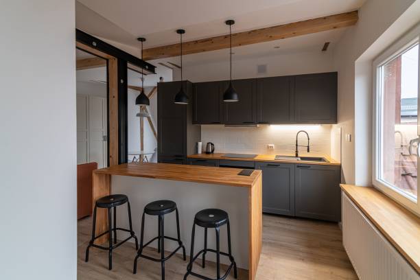 istock Dark gray kitchen furniture in a modern kitchen with a counter 1415035196