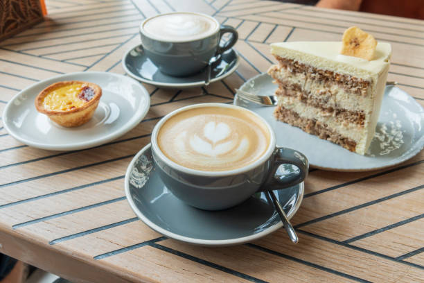 istock Coffee cups and sweets on the cafe table 1415035487