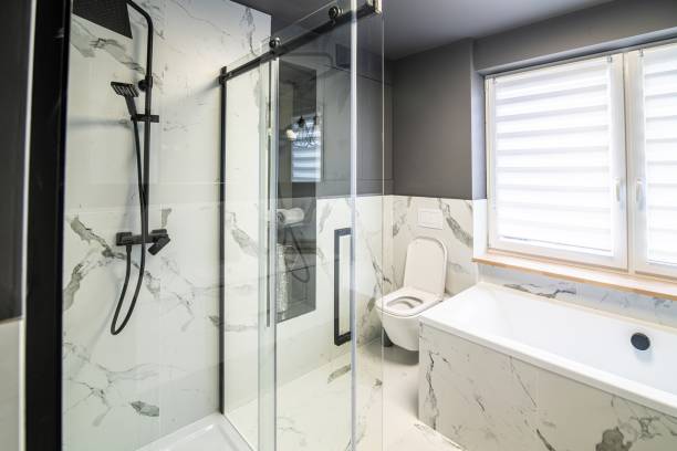 istock Modern flat bathroom with grey walls and bath and shower cabin 1415036477