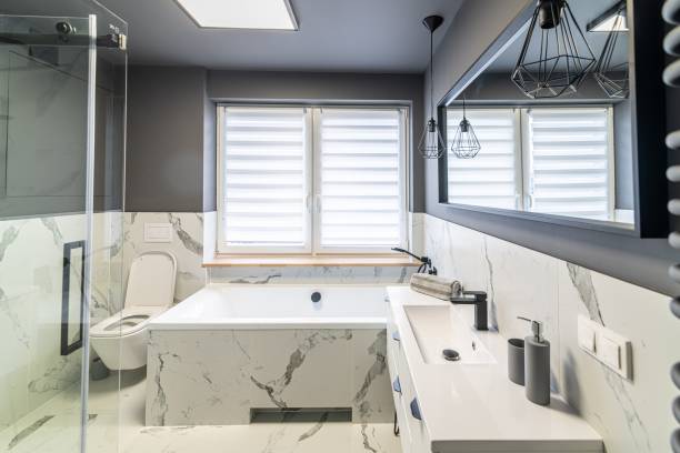 istock Modern flat bathroom with grey walls and bath 1415036485