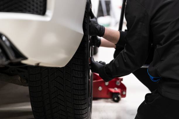 istock Man car service worker changing wheel in car. 1415036609