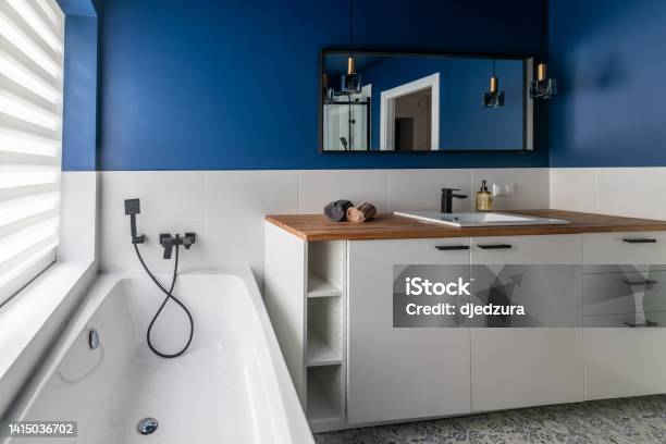Modern Bathroom With Blue Walls White Furniture Stock Photo - Download Image Now - Apartment, Bathroom, Bathtub