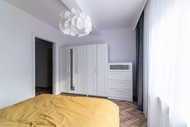 istock Empty mattress on the bed in a small bedroom with a window. 1415036909
