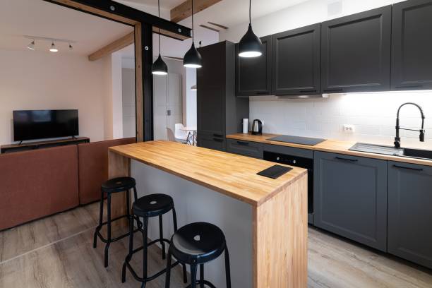 istock Dark gray kitchen furniture in a modern kitchen with a counter 1415036980