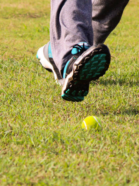 istock Tennis ball on grass. Running feet as Prop 1415038098