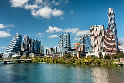 Modern buildings and downtown city skyline view of the Congress Avenue bridge over the Colorado River in Austin Texas USA