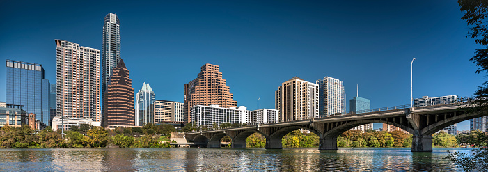 Panoramic city skyline view of the Congress Avenue bridge over the Colorado River in Austin Texas USA