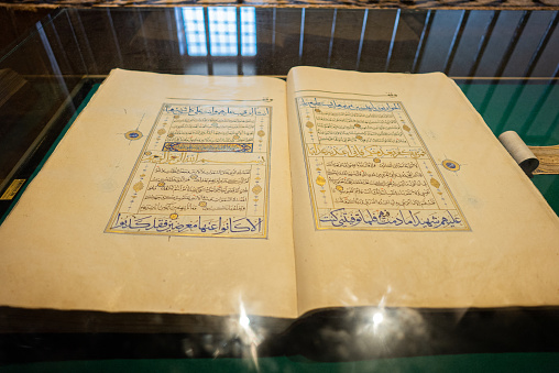 Photo of the Sheets entire Qoran - Koran - Qur'an with the name of Allah, reading and lokinng into Qoran - Koran - Qur'an