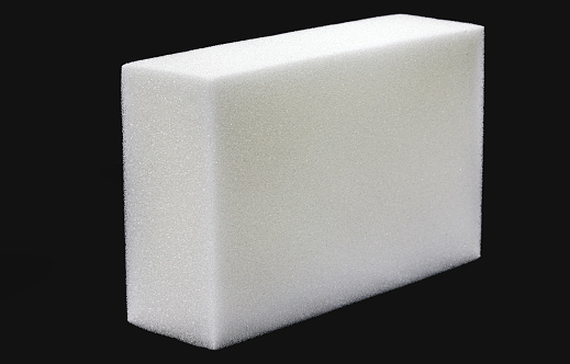 Polyester foam block, used in building construction, packaging, filling or upholstery, isolated black background, copyspace