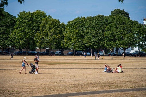 Richmond, United Kingdom - August 14, 2022: Sunday Afternoon on the dried grass of Richmond Green