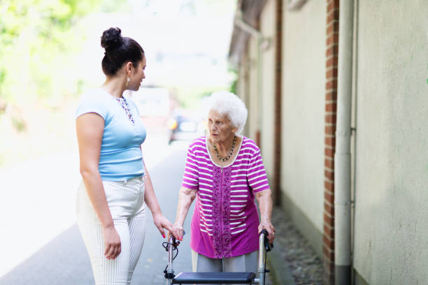 istock Senior woman talking with young hispanic caregiver 1415050972