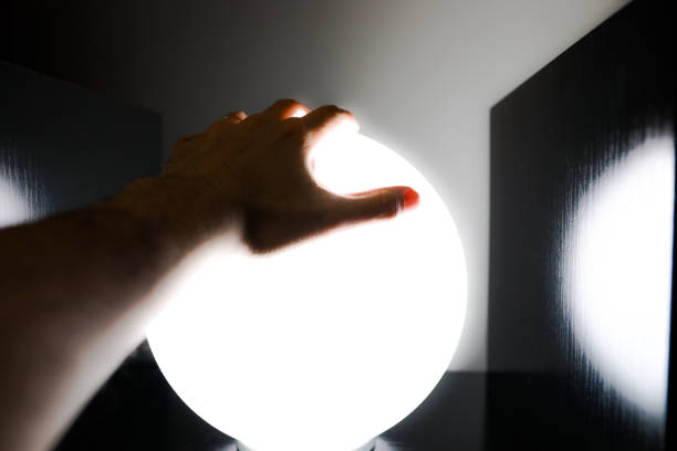 istock A hand clutching a scary white light sphere for halloween. 1415051235