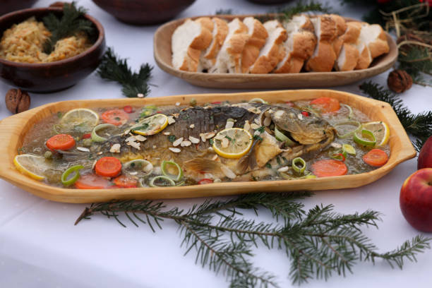 carp with lemon and vegetables on the plate carp with lemon and vegetables on the plate aspic stock pictures, royalty-free photos & images