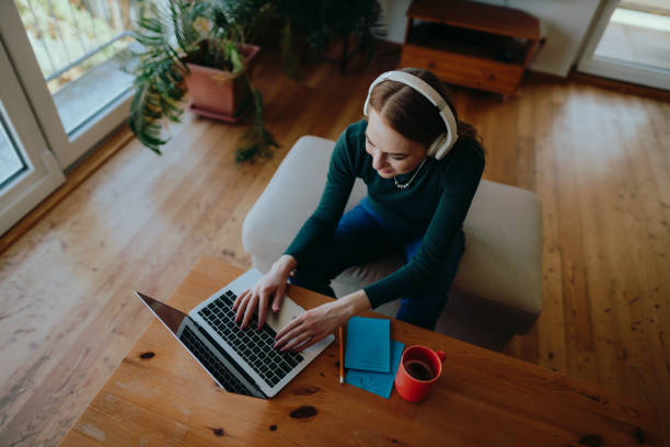 istock Woman using a laptop and having an online class at home 1415053152