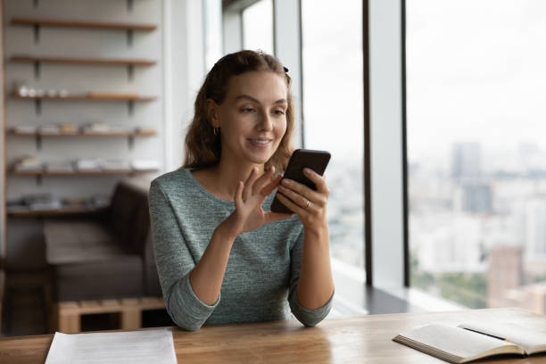 istock Happy millennial gen Z girl using smartphone at work table 1415053186