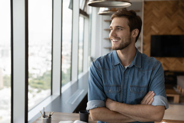 istock Happy dreaming businessman standing by office or home workplace 1415053233