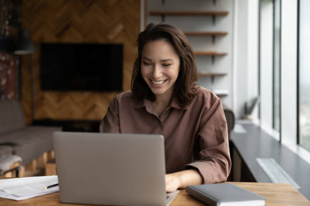 istock Happy business woman working at home office workplace with computer 1415053248