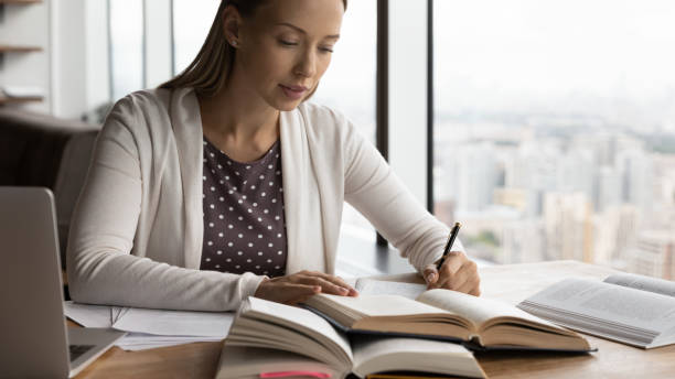 istock Serious hardworking millennial adult student preparing for exam 1415053265