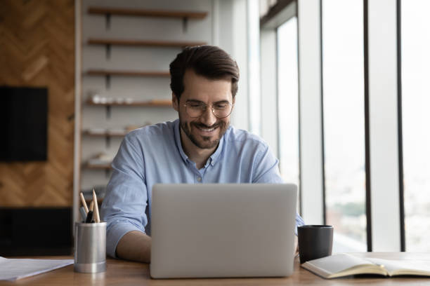 istock Happy business project manager working from home, using laptop 1415053351