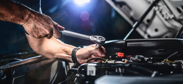istock Auto mechanic working in garage. Repair service. 1415054400