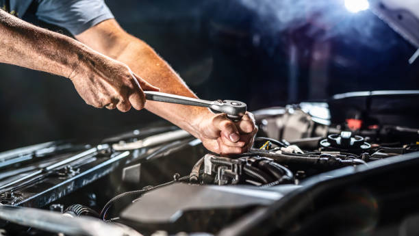 istock Auto mechanic working in garage. Repair service. 1415054401