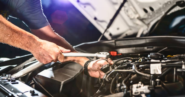 istock Auto mechanic working in garage. Repair service. 1415055103