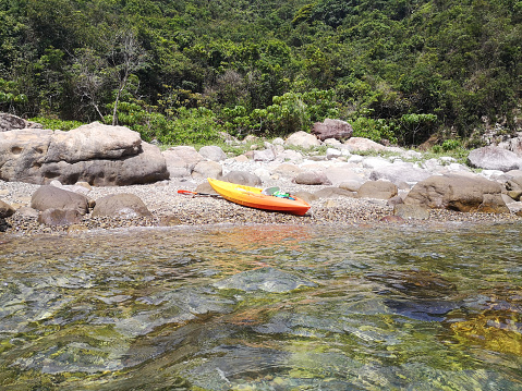 Kayak on a deserted beach by the Clear waters at Sharp Island, the largest island in the Kiu Tsui Country Park located at Port Shelter of Sai Kung, Hong Kong.