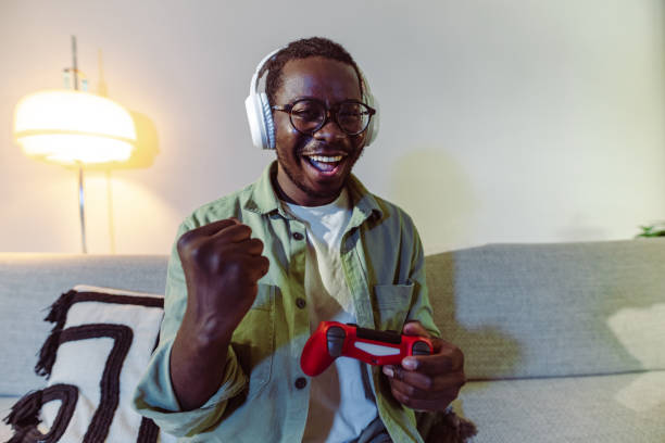 istock Young man plays video games online and wins 1415056460