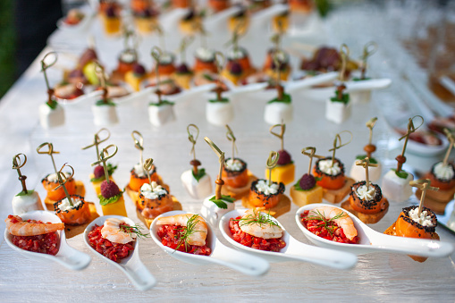 Row of appetizers and starters on the wedding table.