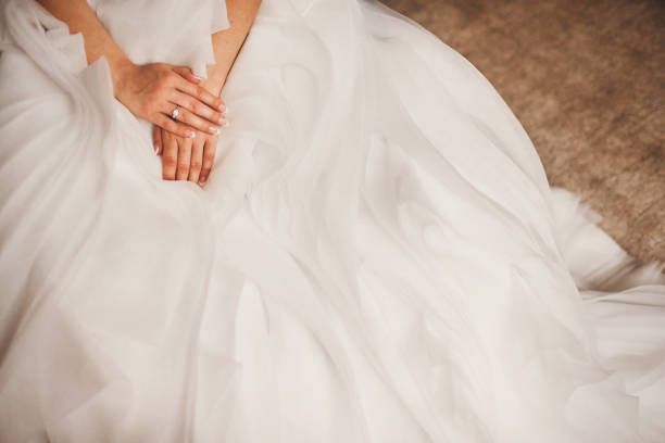 istock Engagement ring on bride's finger during wedding preparations 1415057608