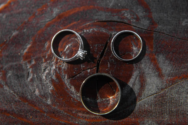 istock Two wedding rings on a wooden table 1415057715