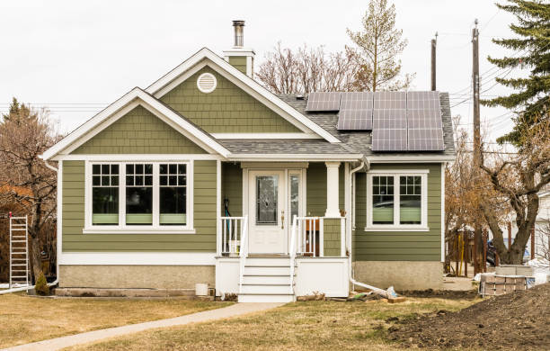 View of an old house renovation with installation of solar batteries in early spring season stock photo