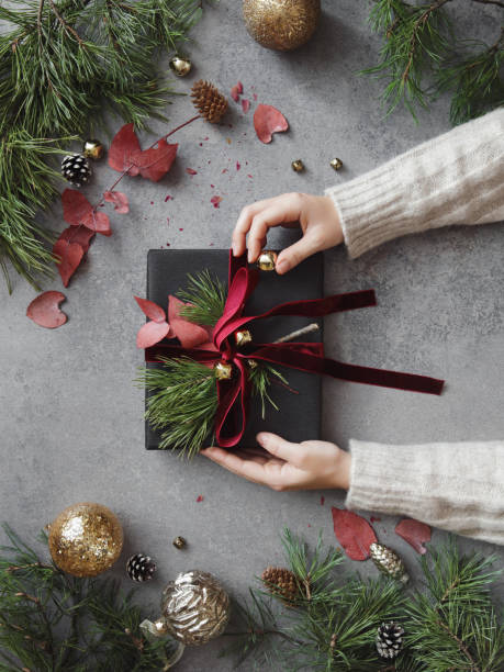 istock Woman decorating Christmas present 1415058778