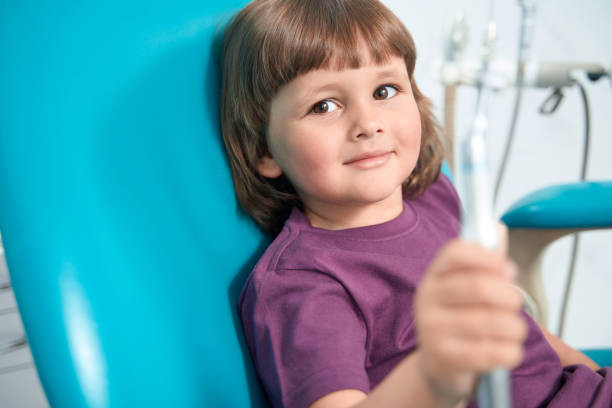 istock Tranquil female child sitting in dentist office before teeth treatment 1415058907