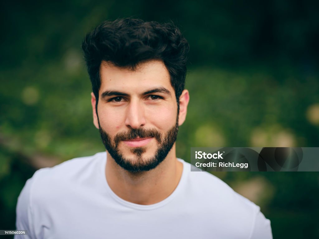 Outdoor Portrait of a Young Adult An outdoor portrait of a young adult looking at the camera. 20-24 Years Stock Photo