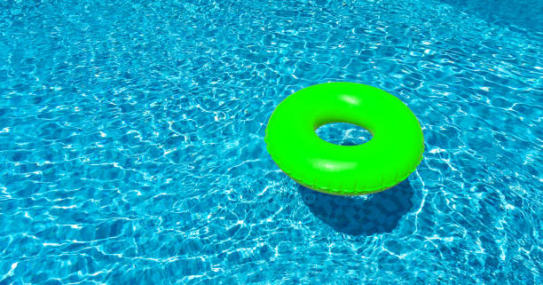 istock Light green ring floating in blue swimming pool. Inflatable ring, rest concept 1415062246