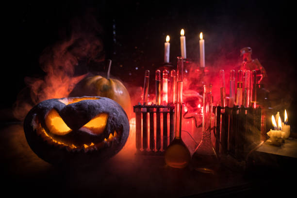istock Halloween still-life background with different elements on dark toned foggy background. Selective focus 1415063587