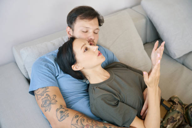 istock Young couple relaxing on a sofa in a bright room 1415063797