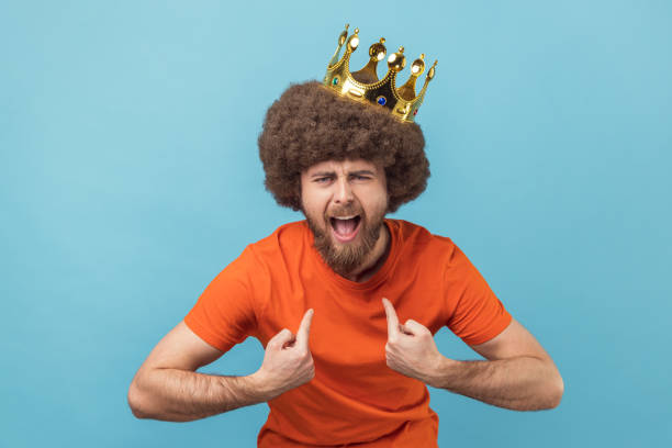 istock Man in golden crown and pointing himself with excite expression, looking with arrogance. 1415065793
