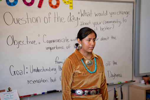 Smiling Young Indigenous Navajo Woman Teacher at the Front of Her Classroom Engaging and Teaching Her Young Students in Monument Valley Utah