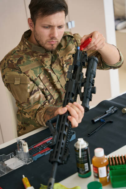 istock Military sniper is cleaning his combat weapon 1415070769