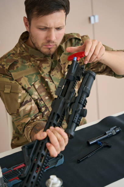 istock Fighter in the process of cleaning military firearms 1415070780