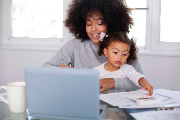 istock Young mother working and spending time with her daughter 1415071398