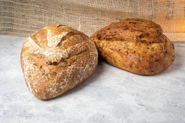istock two sourdough loaf pans on a sack textured surface. bakery concept 1415071556
