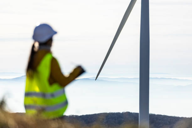 istock Female wind energy engineer working in wind farm. Renewable Energy. 1415074575