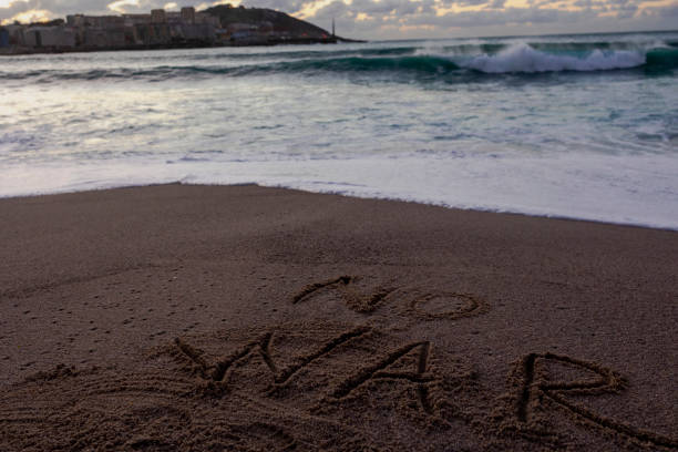istock World peace, an inscription on the sand against war. 1415074825