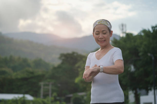 istock Exercise women use smart watch in nature park. 1415077855