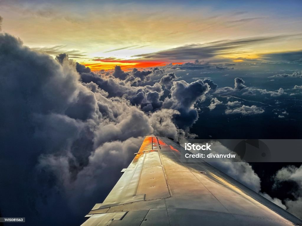 Risky Directions A photo from a plane at sunset with spectacular clouds. However, given the ongoing turmoil in countries, economies and markets, the view often represents the current status quo of volatility, potential storms, turbulence and uncertainty. Is there perhaps light on the horizon? Volatile Stock Photo